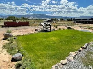 Expansive grass lawn with natural stone border