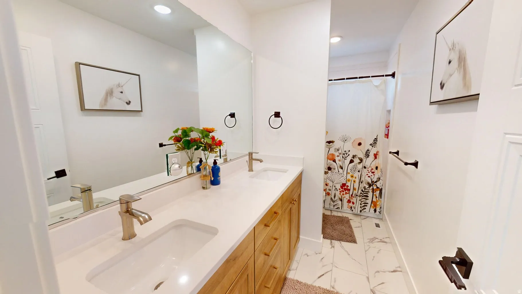 Dual vanity with white undermount sinks, brushed nickel faucets, and a white countertop