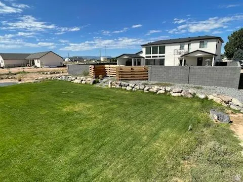 Expansive green lawn with a stone-lined border