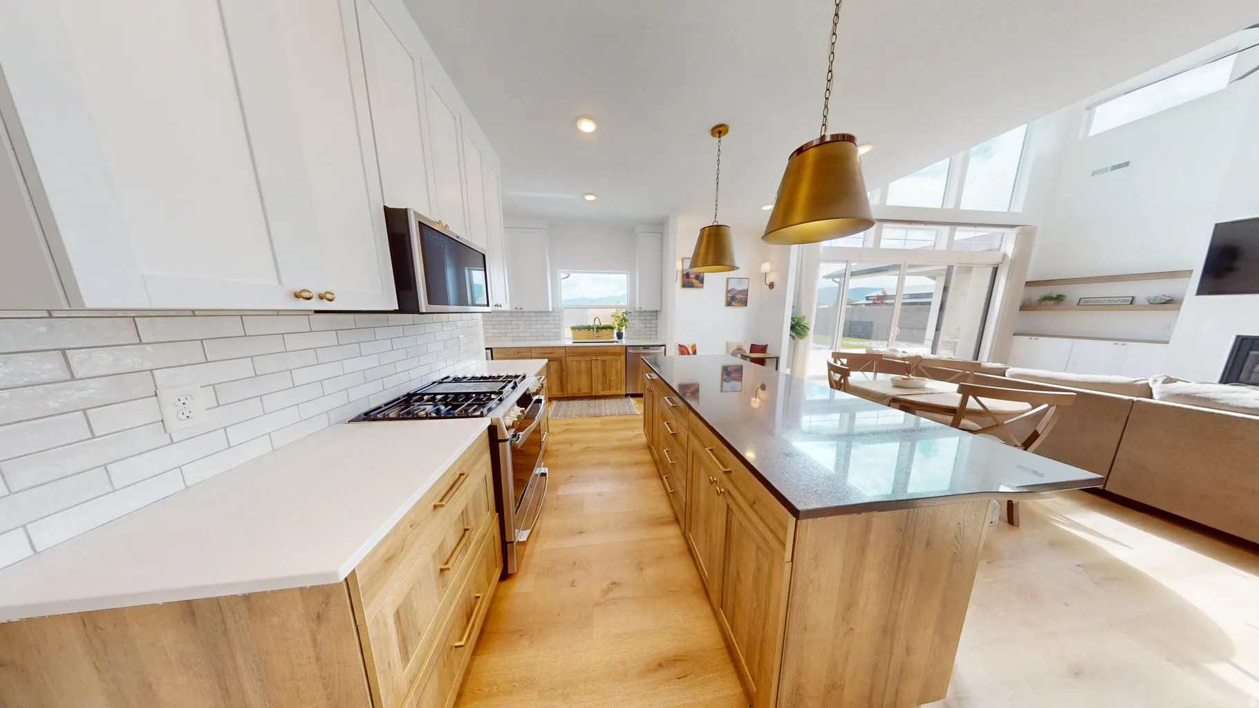 Modern kitchen featuring a gas range, white subway tile backsplash, and light wood-finish flooring