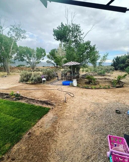 Expansive outdoor area featuring a gravel and dirt landscape