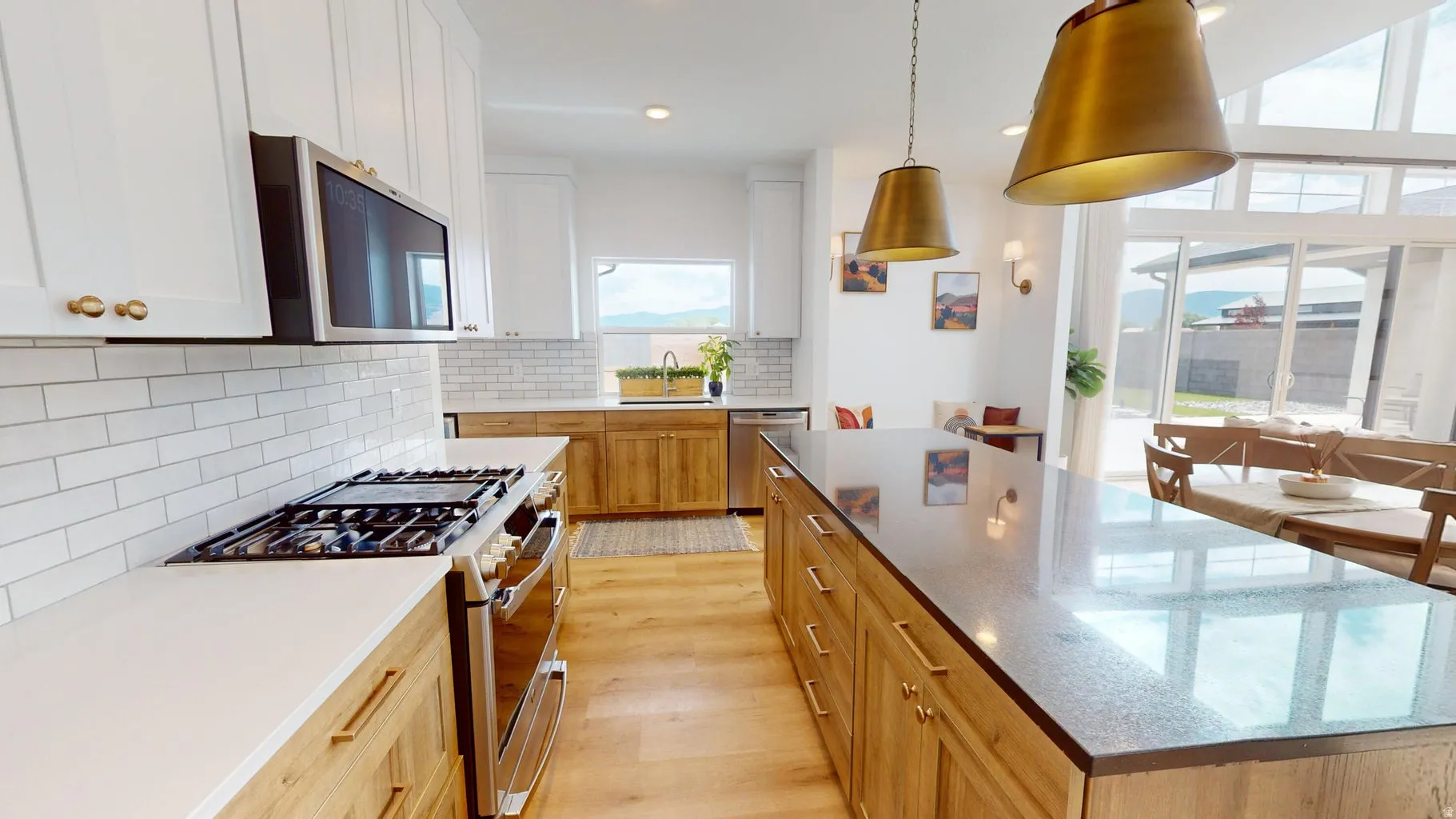 Modern kitchen featuring a gas range, white subway tile backsplash, and light wood-finish flooring