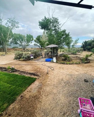 Expansive outdoor area featuring a gravel and dirt landscape