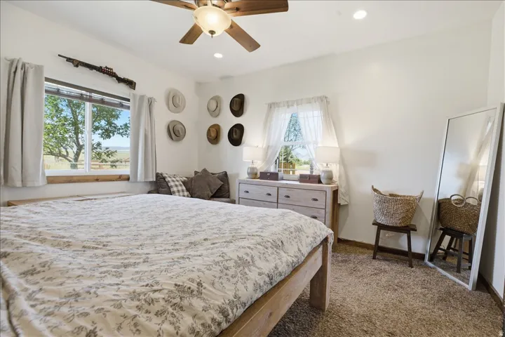 Bedroom featuring a ceiling fan with integrated lighting, recessed lighting, and white walls