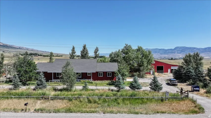 Red-sided residence with an expansive gray roof