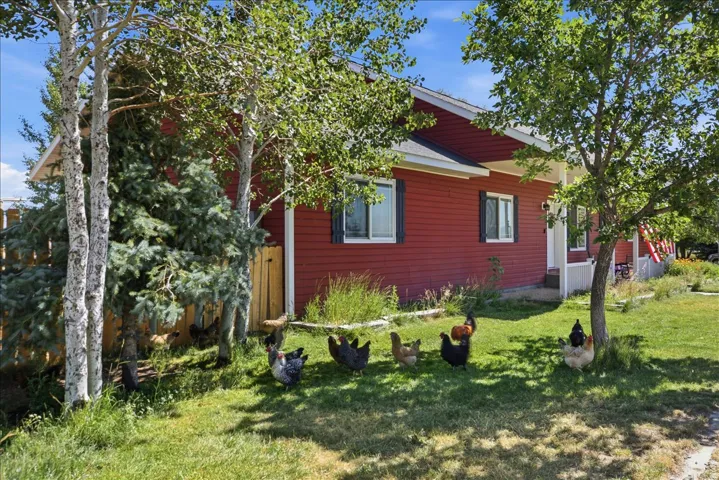 Red exterior siding with white trim and dark window shutters