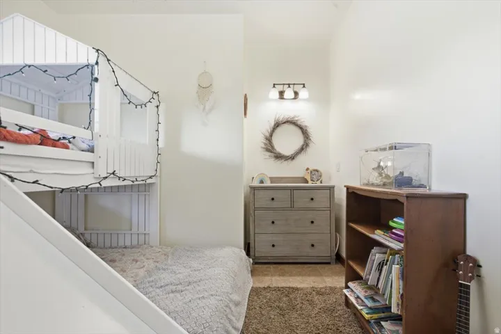 White bunk bed with a house-frame design and integrated slide