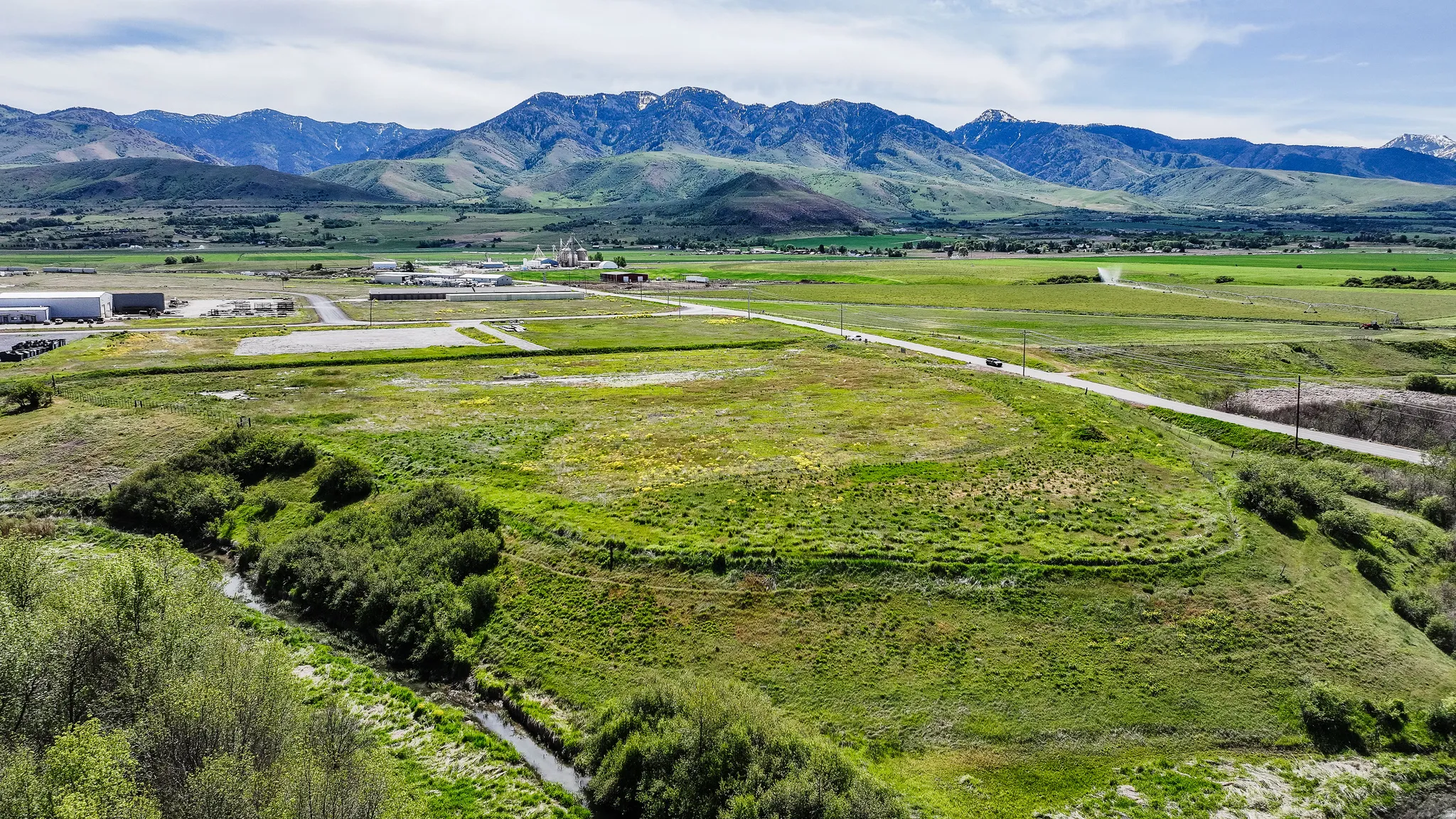 Expansive parcel with abundant green space and a natural stream
