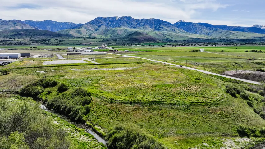 Expansive parcel with abundant green space and a natural stream