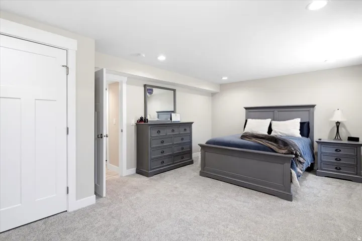 Carpeted room with recessed lighting and a neutral wall color