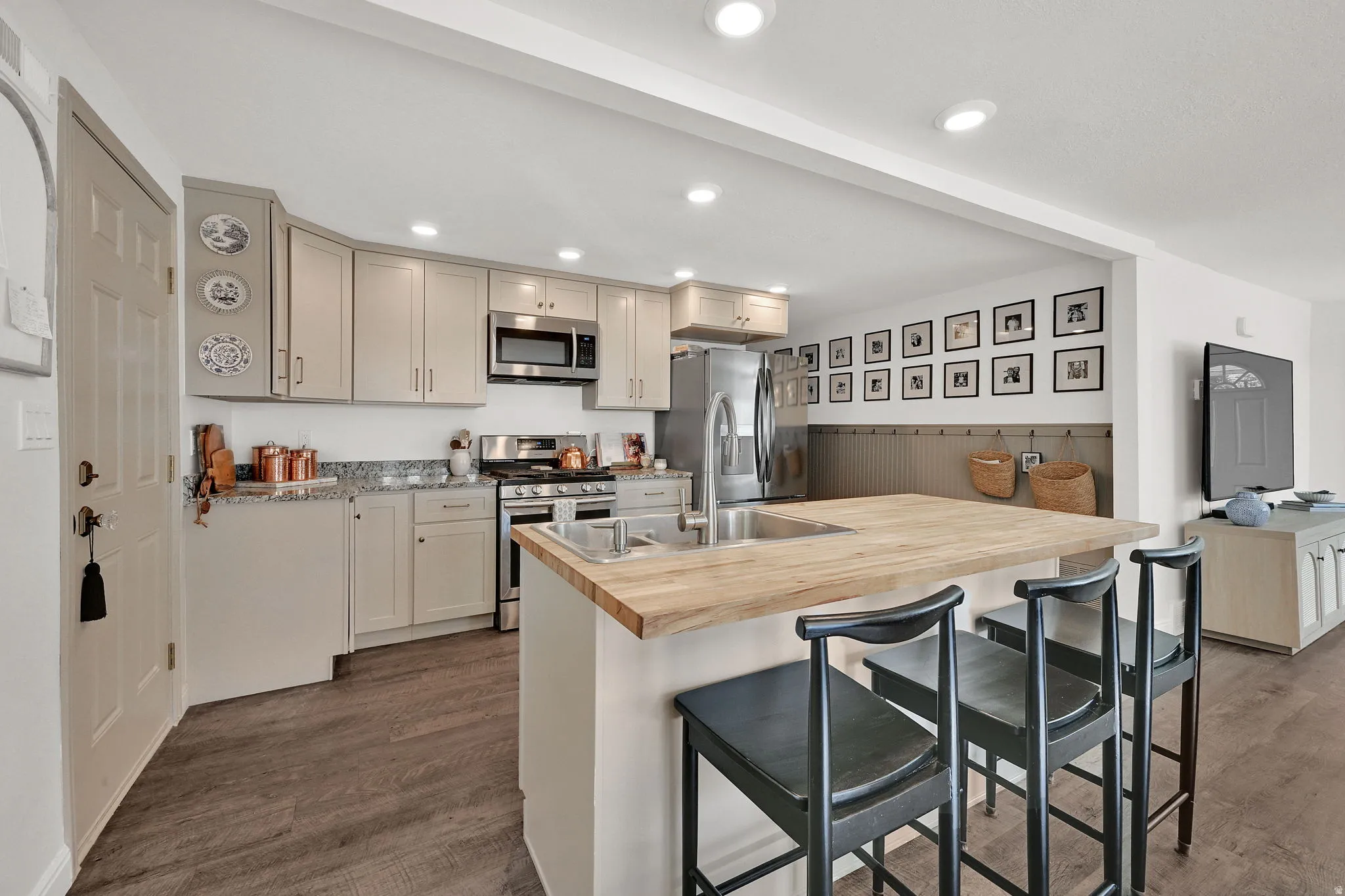 Kitchen featuring wood-finish flooring, recessed lighting, and a peninsula with a butcher block countertop