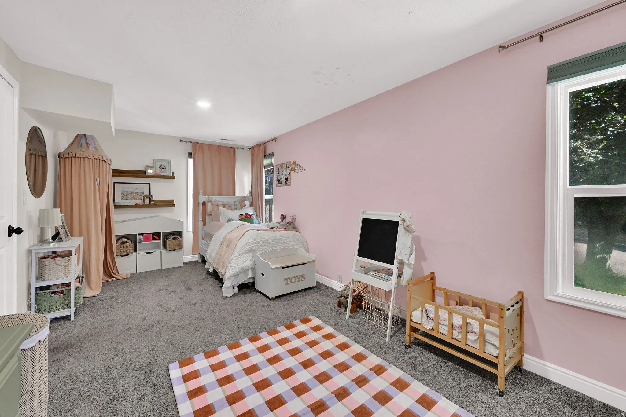 Bedroom #1 - Carpeted room featuring a window with natural light, recessed lighting, and two paneled doors