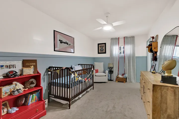 Bedroom #2 - Spacious room featuring carpet flooring, a ceiling fan with integrated lighting, and a two-tone wall treatment