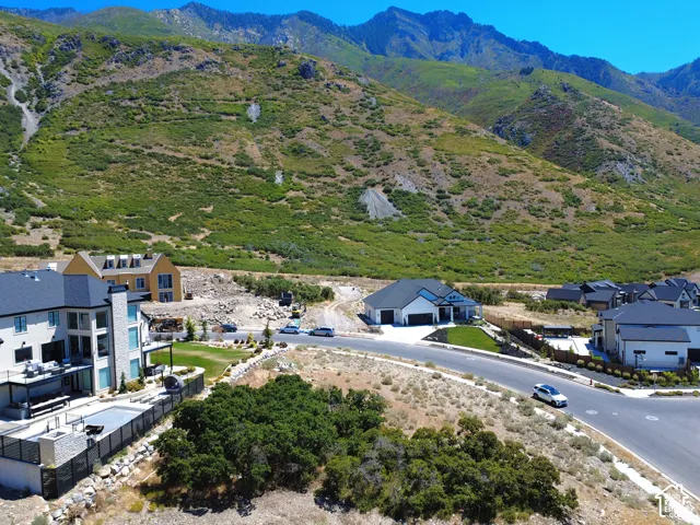 Expansive mountain backdrop with a residential street featuring modern homes
