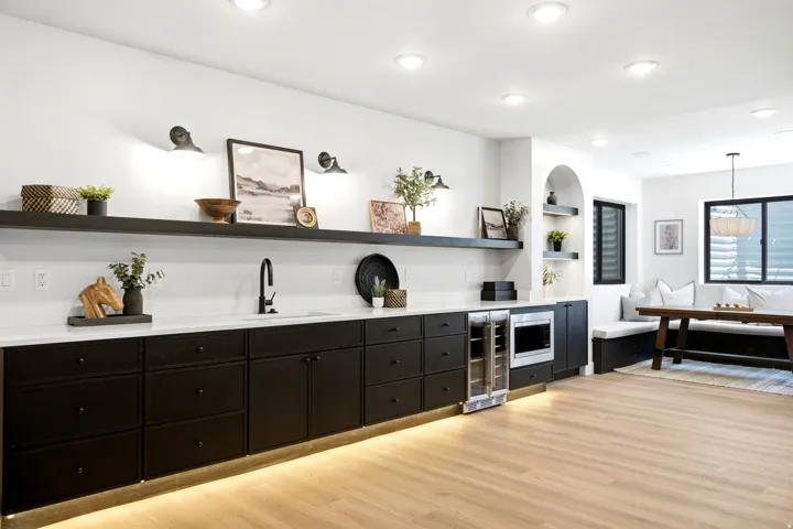 Expansive entertainment space featuring light wood-finish flooring