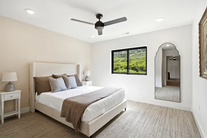 Recessed lighting and a contemporary ceiling fan provide ambient illumination