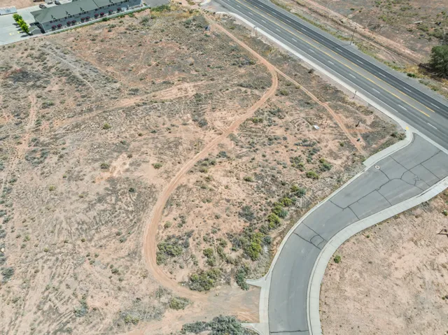 Expansive undeveloped land parcel featuring existing paved roadways, direct road frontage, and a partially developed cul-de-sac