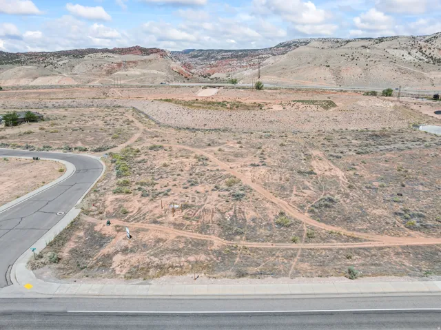 Expansive vacant land parcel featuring a paved road frontage