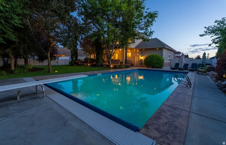 Rectangular swimming pool with a diving board and integrated steps