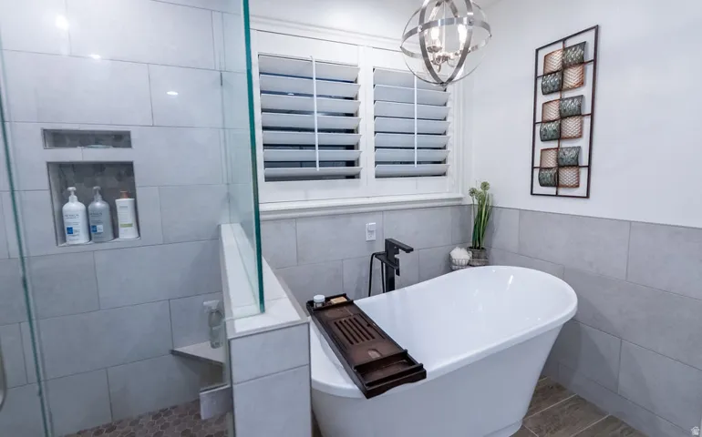 Freestanding soaking tub with a floor-mounted matte black faucet