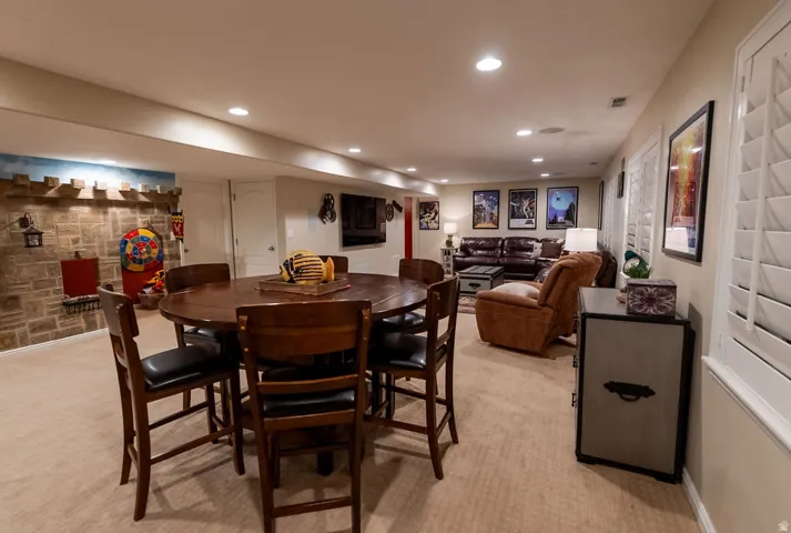 Spacious lower-level entertainment area featuring recessed lighting and plush carpet flooring