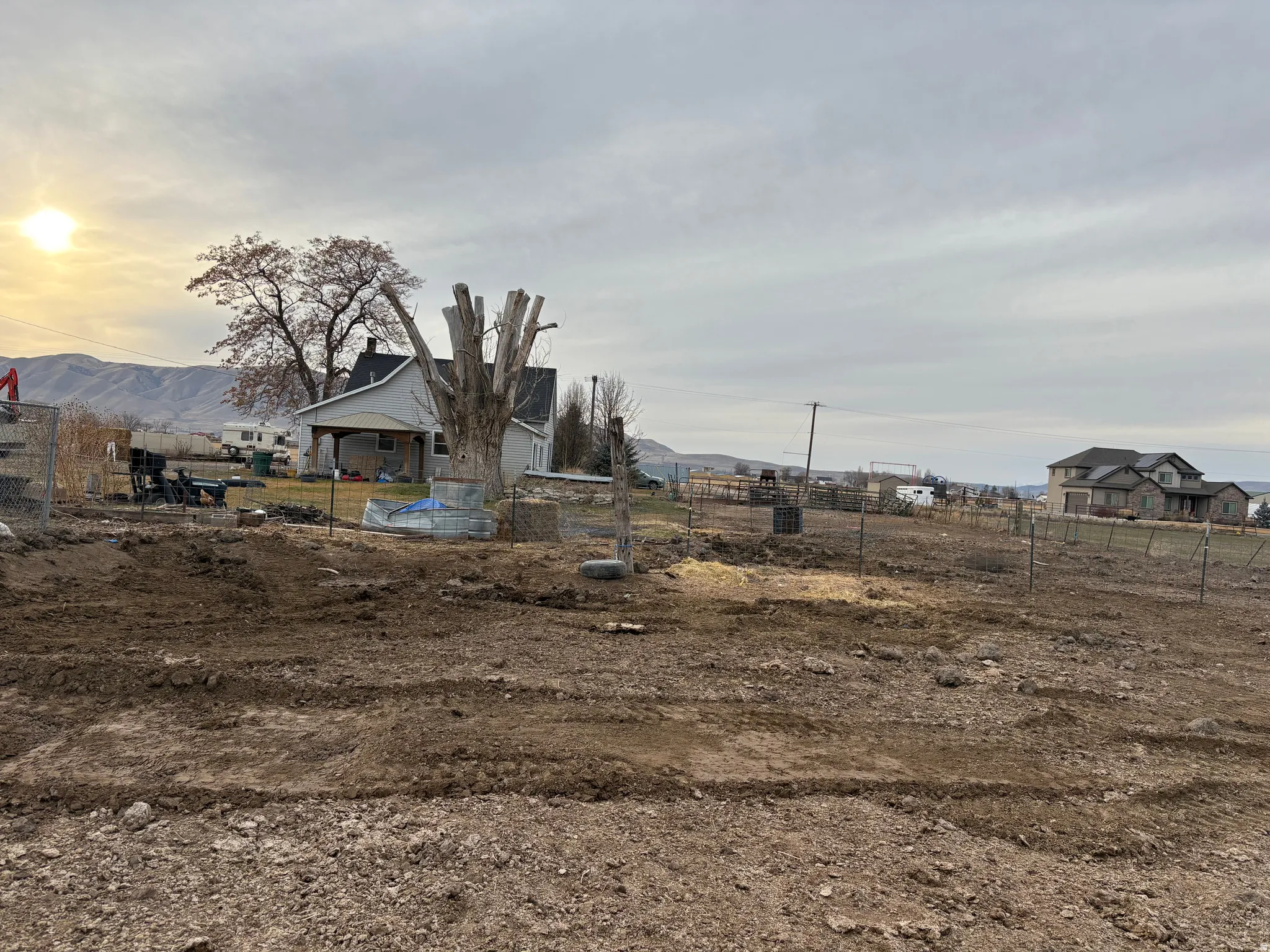 Expansive land parcel featuring existing fencing and a level, cleared area