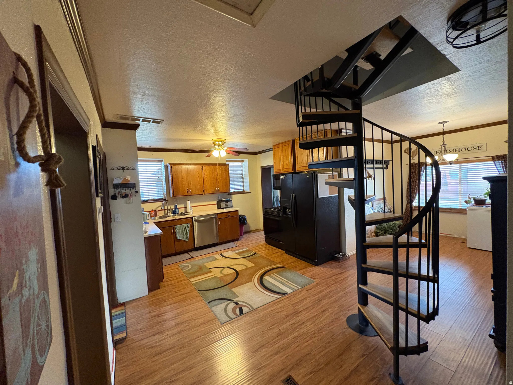 Black metal spiral staircase with wood-finish treads