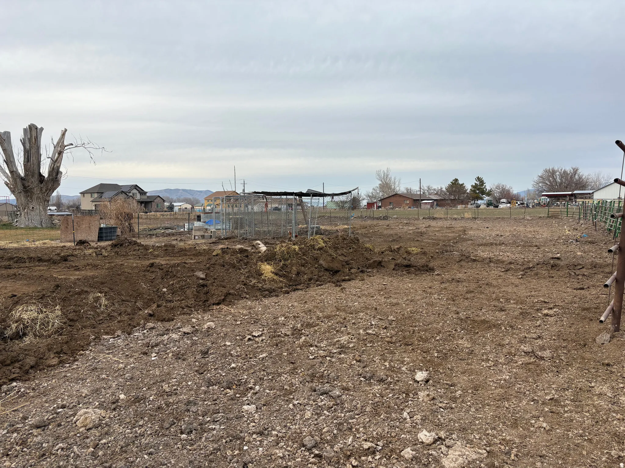 Expansive lot featuring cleared ground and surrounding distant structures