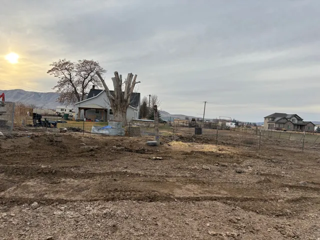 Expansive land parcel featuring existing fencing and a level, cleared area
