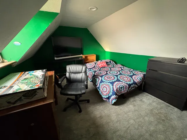Attic room featuring sloped ceilings, recessed lighting, and soft gray carpeting