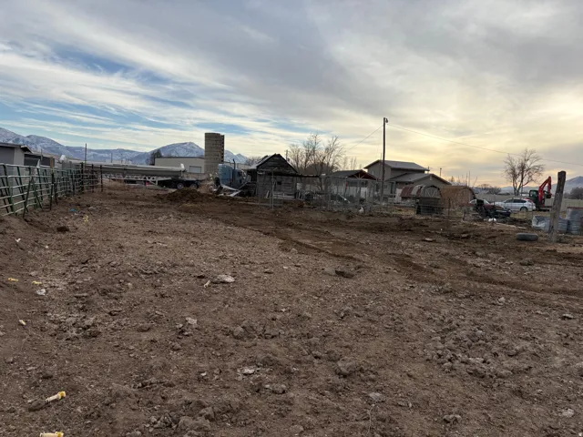 Expansive cleared land parcel featuring agricultural fencing