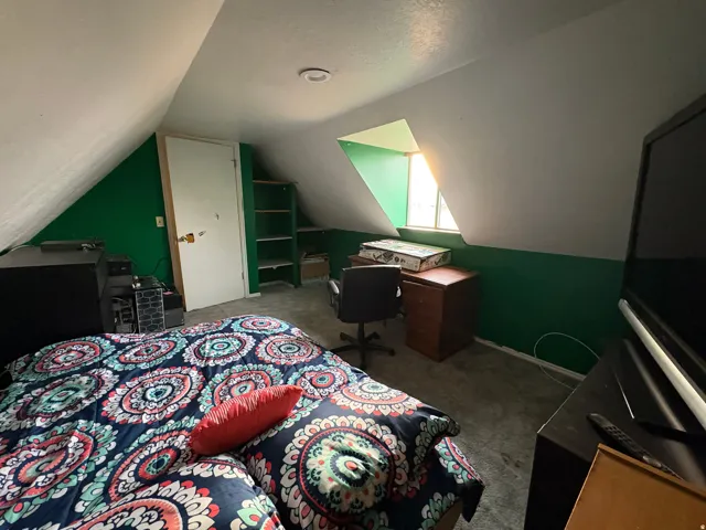 Room featuring a window, built-in shelving, white door, and recessed lighting