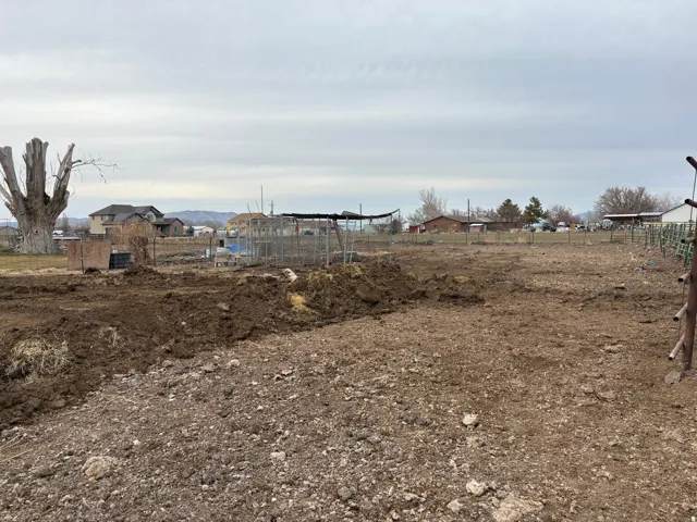 Expansive lot featuring cleared ground and surrounding distant structures