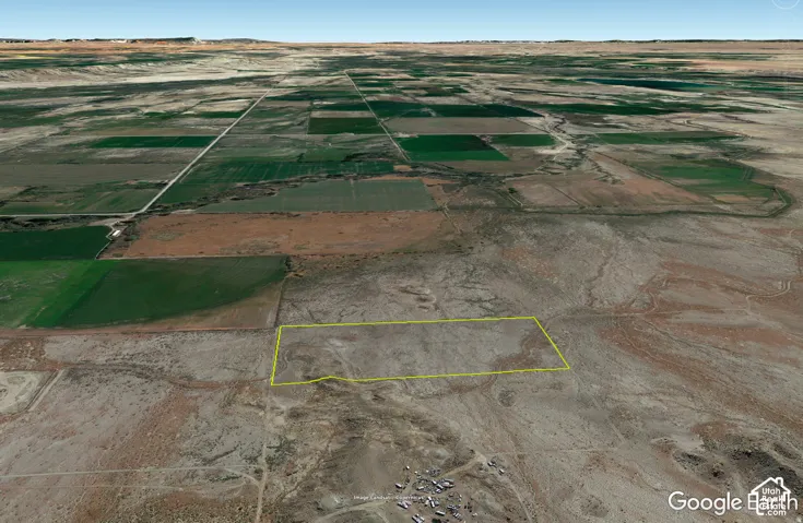 Expansive aerial perspective showcasing a large land parcel outlined in yellow