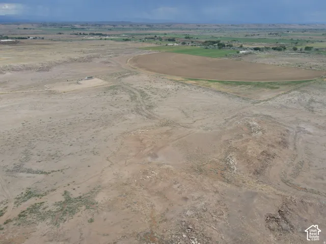 Expansive undeveloped terrain featuring varied topography and distant cultivated fields