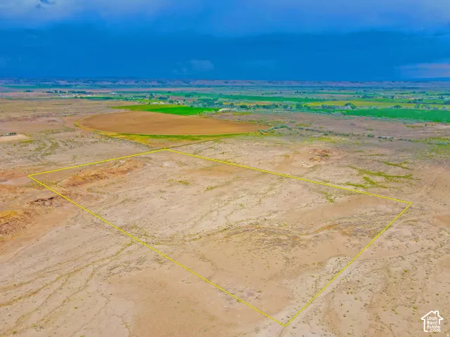 Expansive undeveloped land parcel outlined in yellow, featuring a large, relatively flat topography