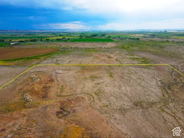 Expansive undeveloped land outlined by a yellow boundary, featuring natural terrain
