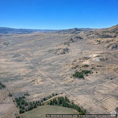 Expansive undeveloped terrain featuring varied topography, natural vegetation, and distant mountainous formations