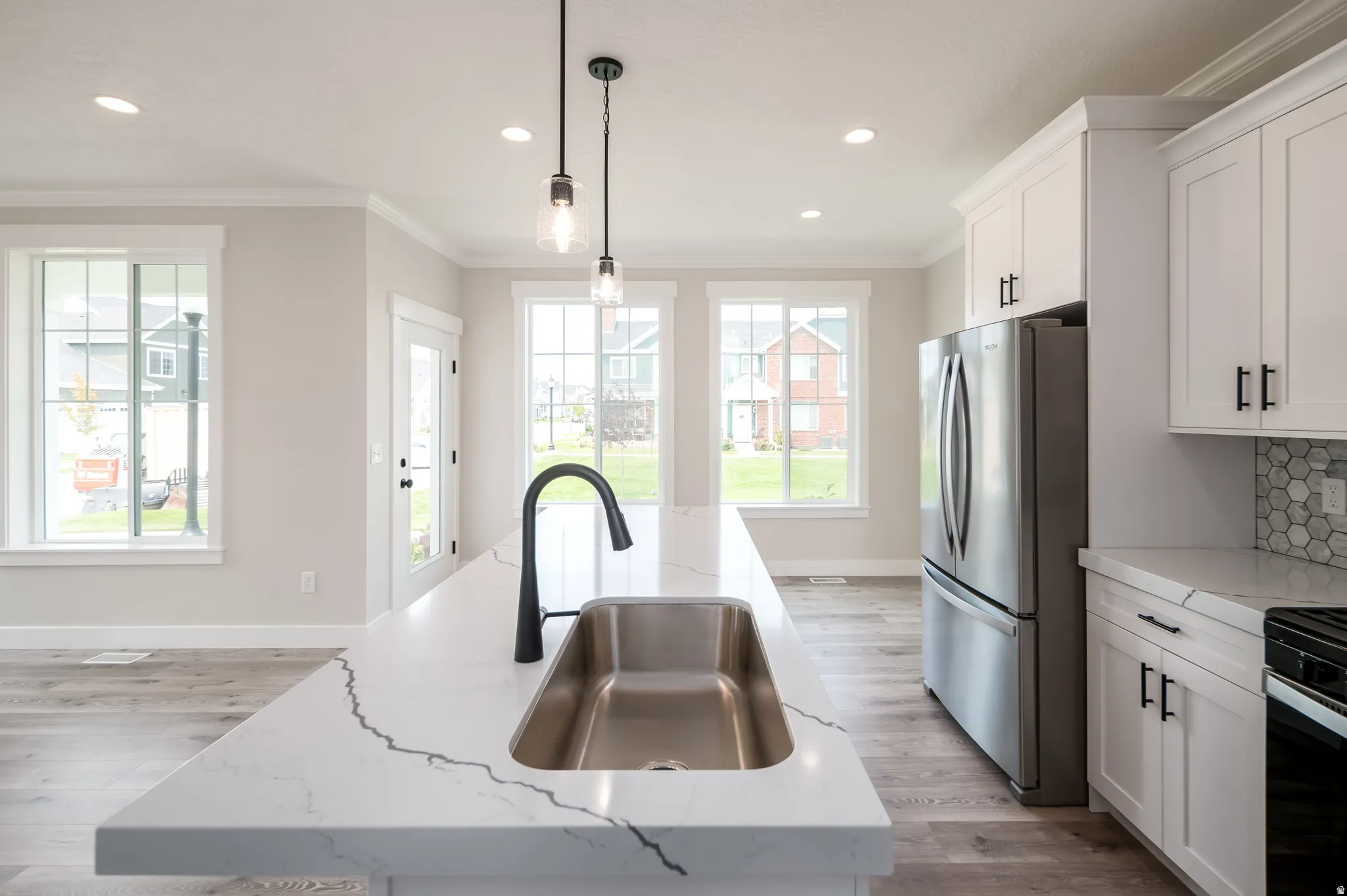 Spacious kitchen island featuring a deep undermount sink and matte black faucet