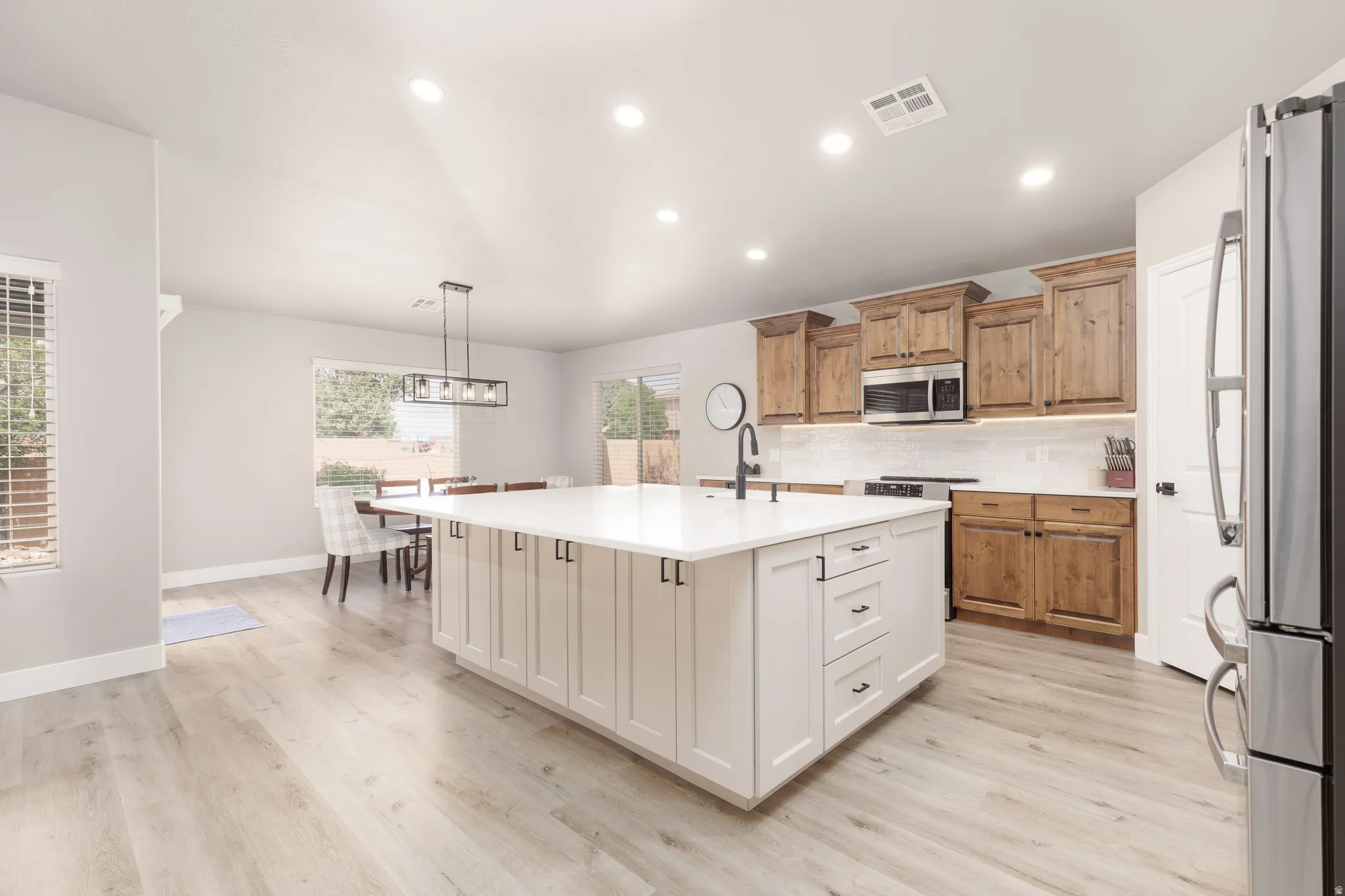 Large custom kitchen island with bar seating and lots of storage