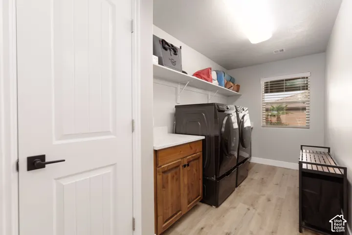 Large laundry room with closet, shelving and cabinet storage