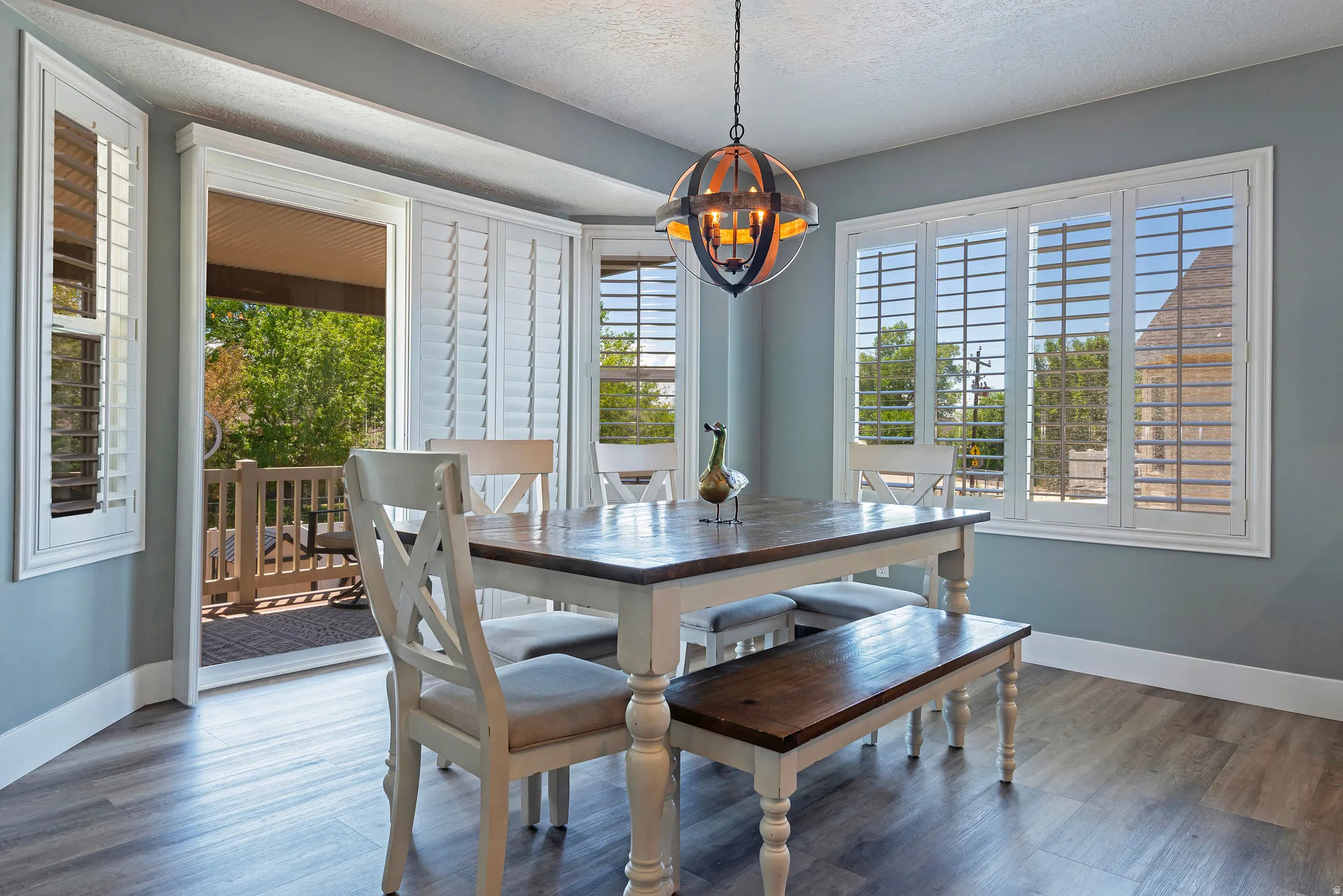 Dining area with wood-finish flooring and light blue walls