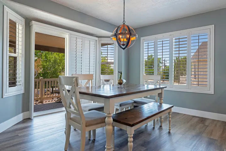 Dining area with wood-finish flooring and light blue walls