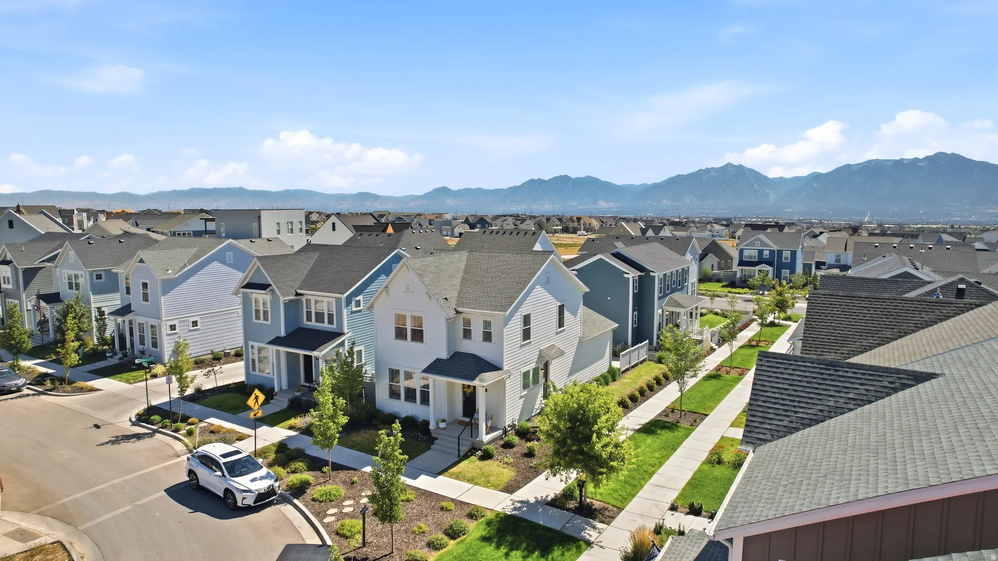 Residential community featuring a mix of two-story homes with varied exterior siding and pitched roofs