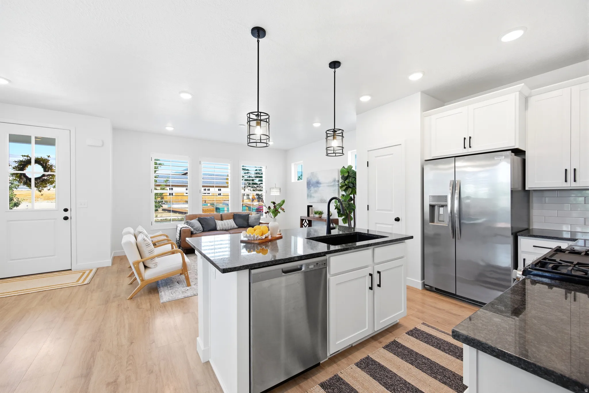 Open-concept main living area with wood-finish flooring