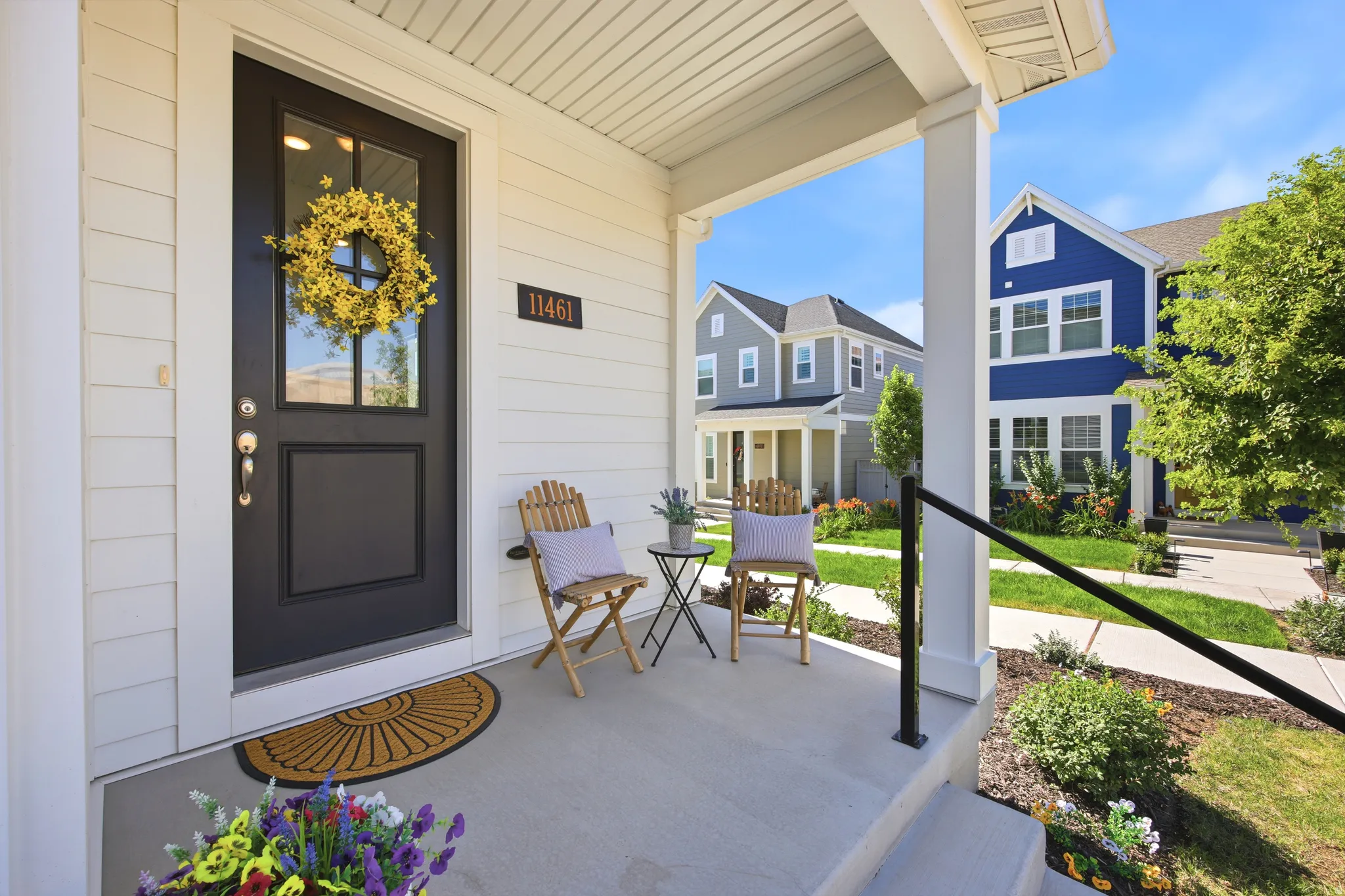 Covered front porch with white siding exterior