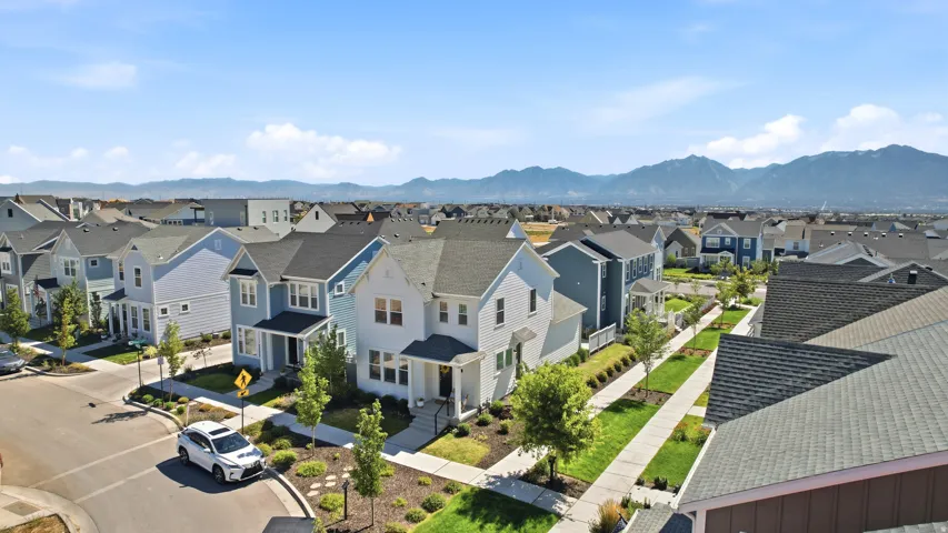 Residential community featuring a mix of two-story homes with varied exterior siding and pitched roofs