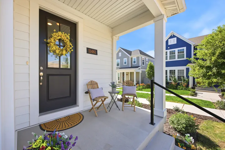 Covered front porch with white siding exterior