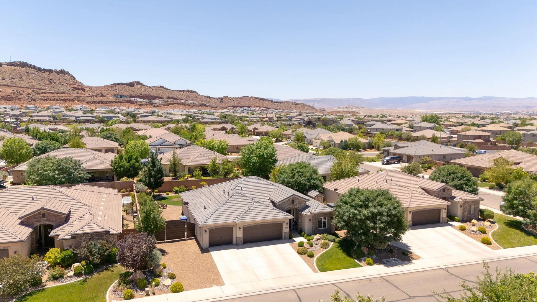Expansive residential neighborhood featuring single-story homes with tile roofs, mature landscaping, and multi-car garages