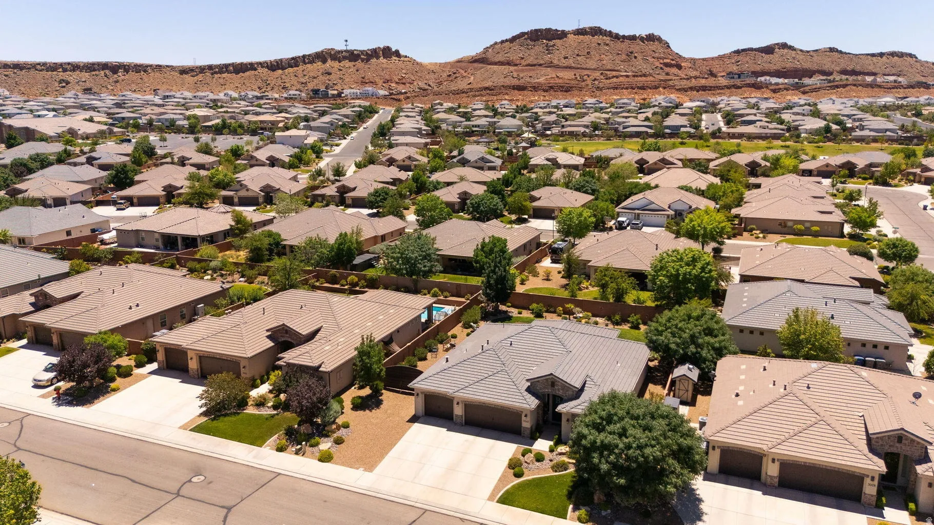 Expansive residential area featuring numerous single-story homes, individual driveways, and mature landscaping